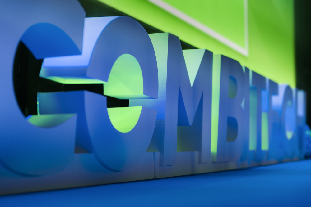 Combitech logo on stage with green and blue lights.